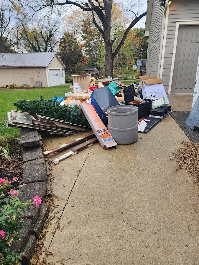 Dumpster being loaded with debris for Roofing Dumpster Rental in Tigard